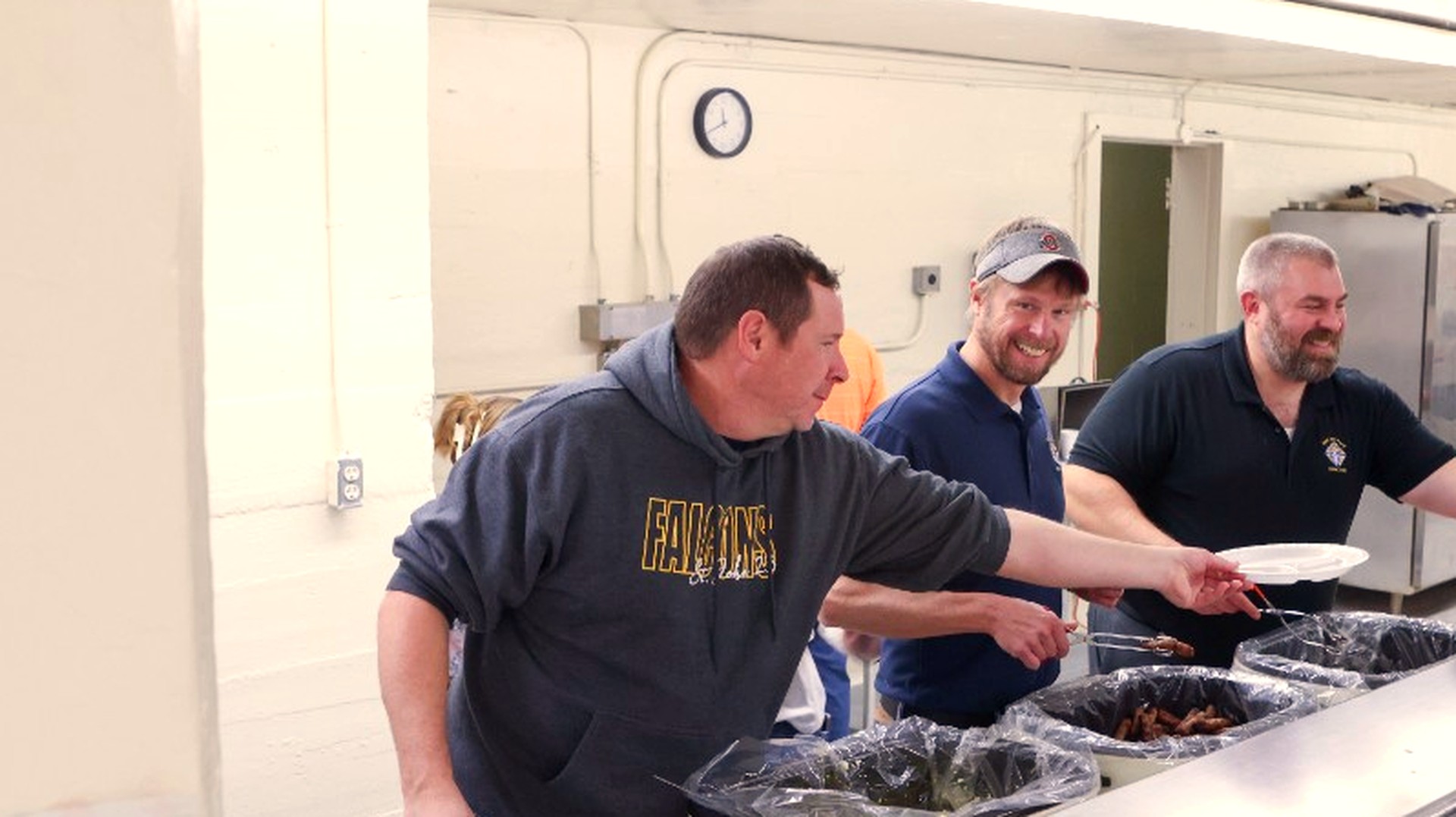 Council members serving a community meal